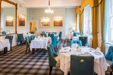 Bright dining room in Old Ground Hotel with cosy tables and elegant decor, ready for guests.