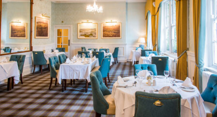 Bright dining room in Old Ground Hotel with cosy tables and elegant decor, ready for guests.