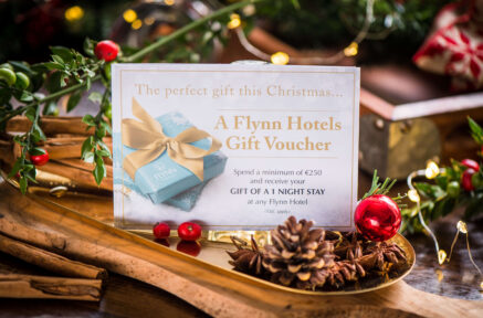 Festive gift voucher display with pinecones and decorations for Flynn Hotels.