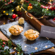Festive pies and a card from Old Ground Hotel on a decorated table.