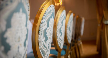 Elegant chairs in a warmly lit Old Ground Hotel dining room.