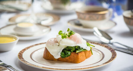 Elegant breakfast setting with poached eggs on toast at a cosy hotel restaurant.
