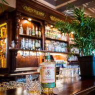 Cosy Old Ground Hotel bar with Irish whiskey and warm lighting.