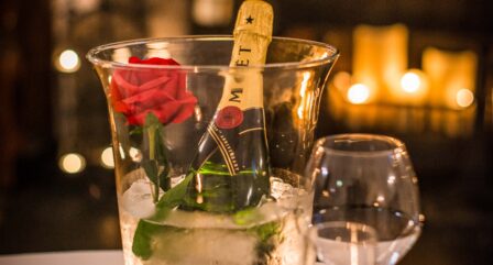 Romantic table setting with champagne and rose at cosy Old Ground Hotel.