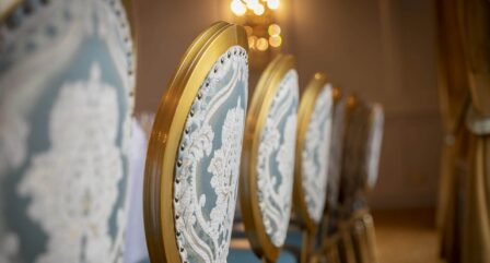 Elegant chairs and warm lighting in a cosy hotel dining area.