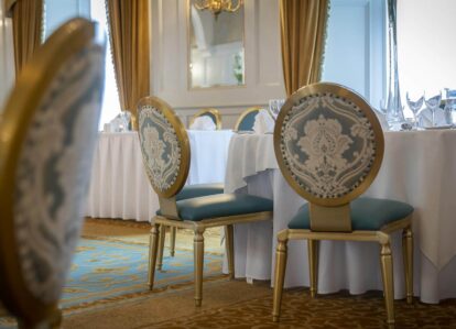 Elegant dining room in Old Ground Hotel with ornate chairs and a beautifully set table.