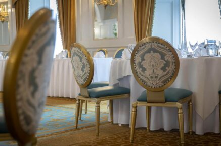 Elegant dining room in Old Ground Hotel with ornate chairs and a beautifully set table.