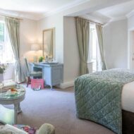 Elegant hotel room with soft lighting, cosy seating, and a welcoming atmosphere.